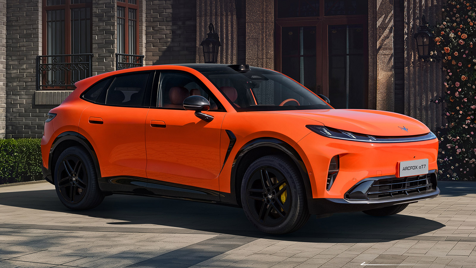 Orange Arcfox Alpha T7 shown from the front three-quarter angle, featuring black wheels and yellow brake calipers.