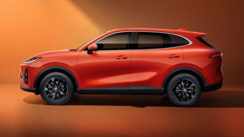 Side profile of an orange Chery Fulwin T7 electric SUV against a studio backdrop.