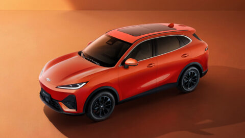 High-angle front three-quarter view of an orange Chery Fulwin T7 with black wheels and a panoramic glass roof.
