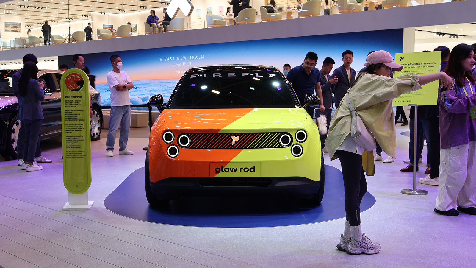 Front view of an orange-and-lime Firefly EV displayed at the 2026 Beijing Auto Show.