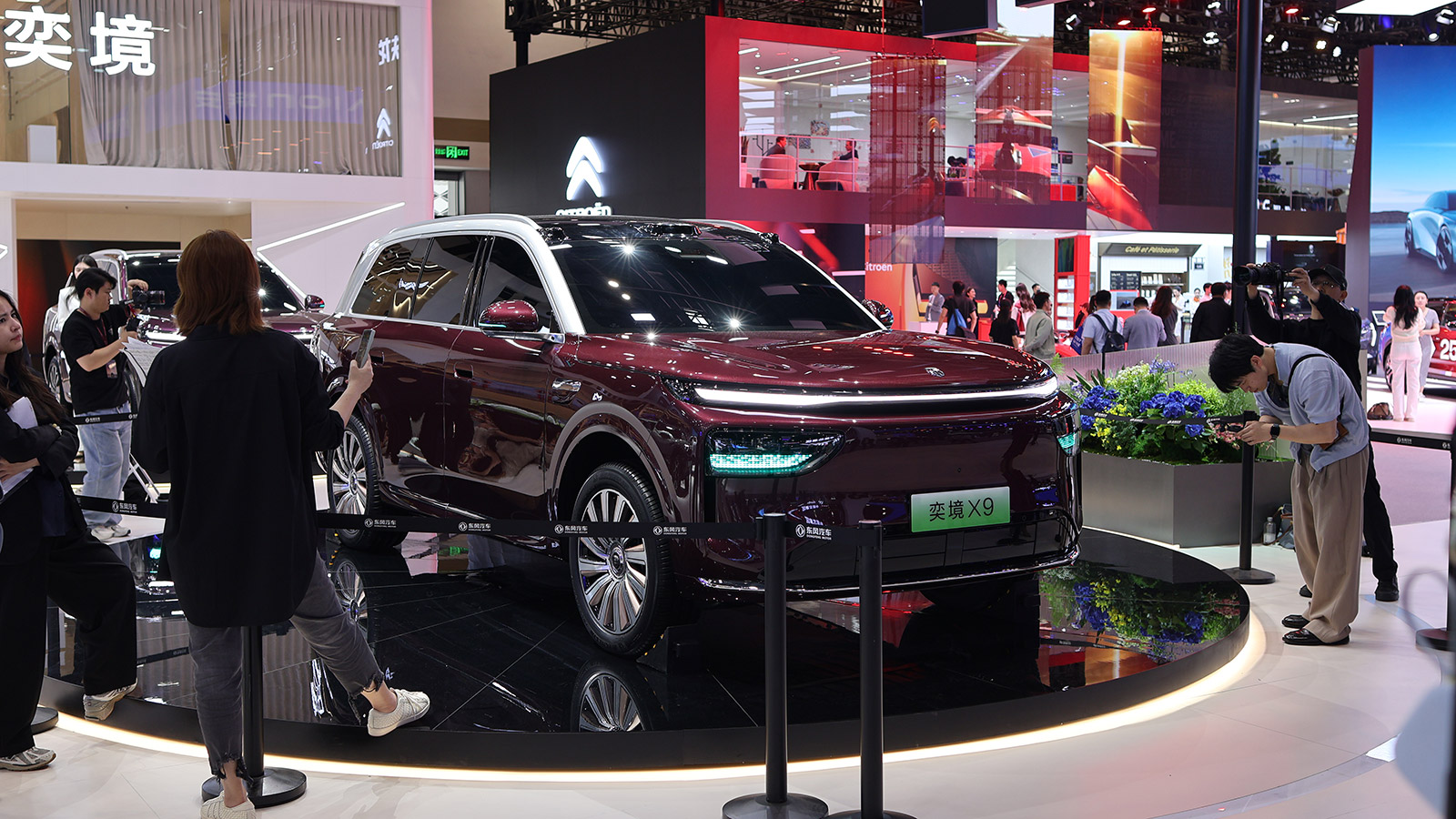A burgundy Epicland X9 SUV on display as visitors take photos at the 2026 Beijing auto show.