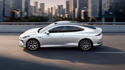 Side view of the all-new silver IM L6 driving on an elevated urban road.