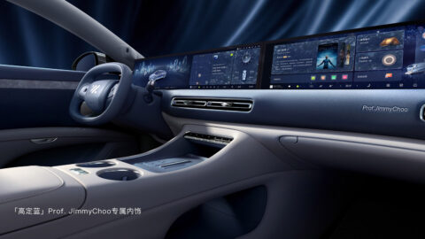 Blue interior of the IM L6 Prof. Jimmy Choo edition featuring wide digital displays and a yoke-style steering wheel.