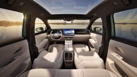 Interior of the FAW-Volkswagen ID. AURA T6 with its front seats folded flat, digital displays and panoramic glass roof visible.