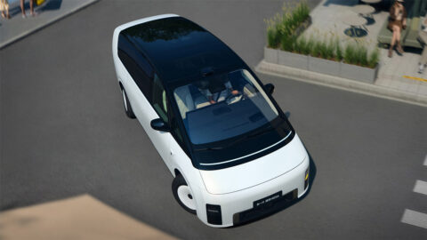 High-angle view of a white new-generation Li Mega turning along an urban street.