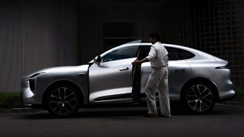 A man opens the driver's door of the all-new silver IM LS6 SUV.
