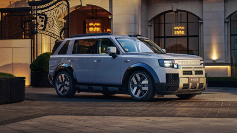 A silver Freelander 8 shown from the front three-quarter angle outside an illuminated building.