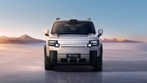 Front view of a silver Freelander 8 against a mountain landscape.