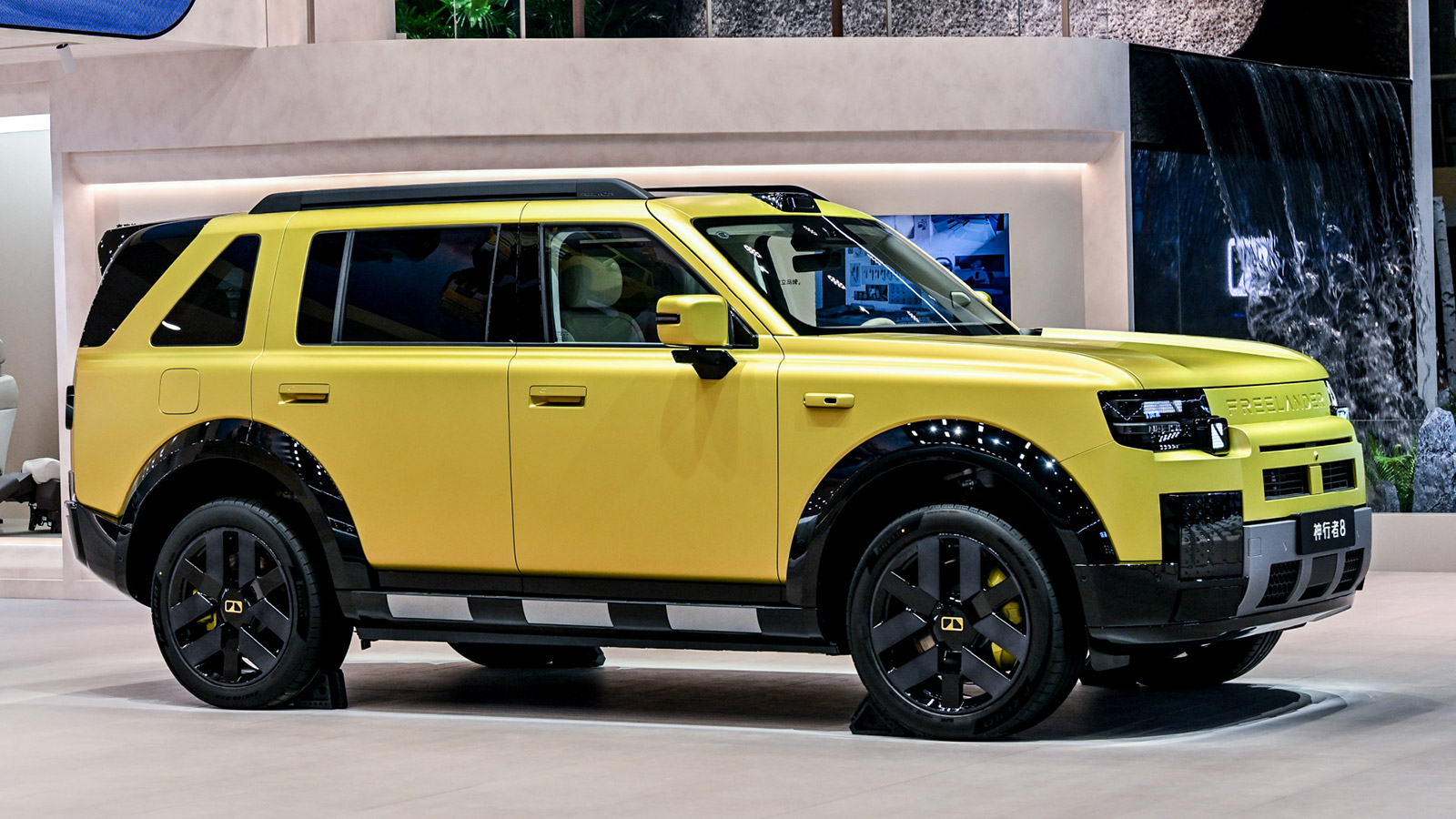 A yellow Freelander 8 SUV on indoor display, shown from the front-right side.
