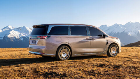 Rear three-quarter view of the Voyah Dream 9 against a mountainous landscape, showing its full-width taillight and chrome trim.