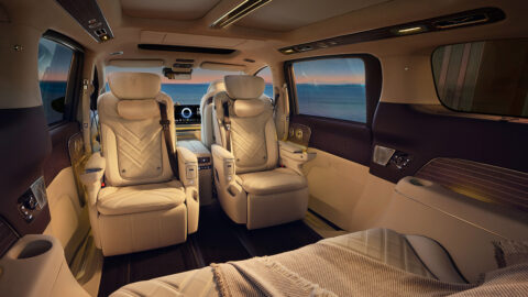 Interior of the Voyah Dream 9 showing 2 cream-colored second-row captain's chairs, panoramic windows and premium trim.