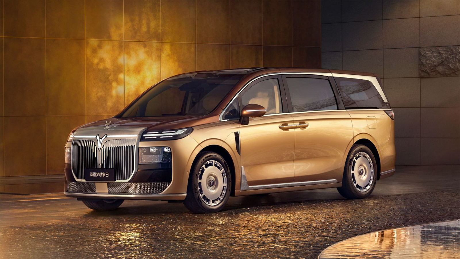 A two-tone gold and brown Voyah Dream 9 luxury MPV shown from the front three-quarter angle.