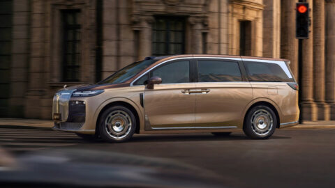 A two-tone Voyah Dream 9 luxury MPV driving through a city, shown in side profile.