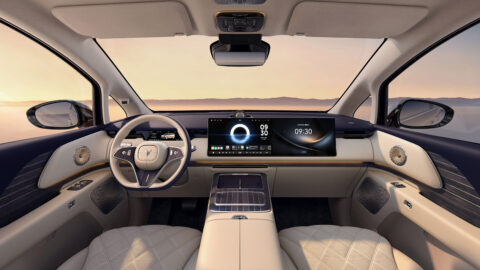 Front cabin of the Voyah Dream 9 featuring dual dashboard displays, a panoramic glass roof and a light-colored interior.