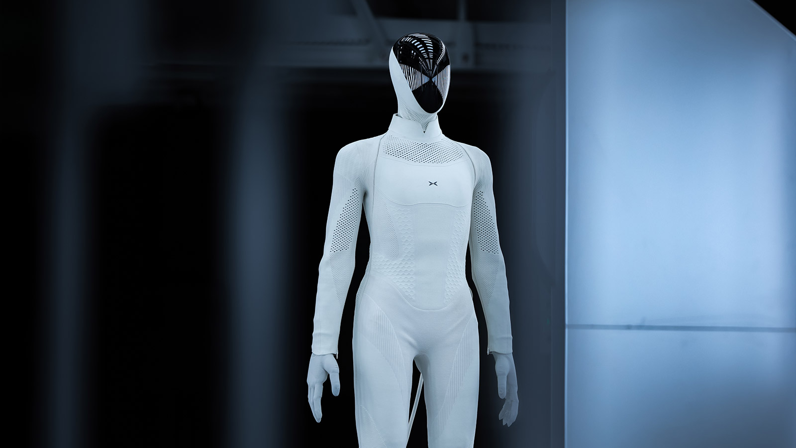 Xpeng's Iron humanoid robot with a white body and glossy black faceplate at the company's robot manufacturing facility.