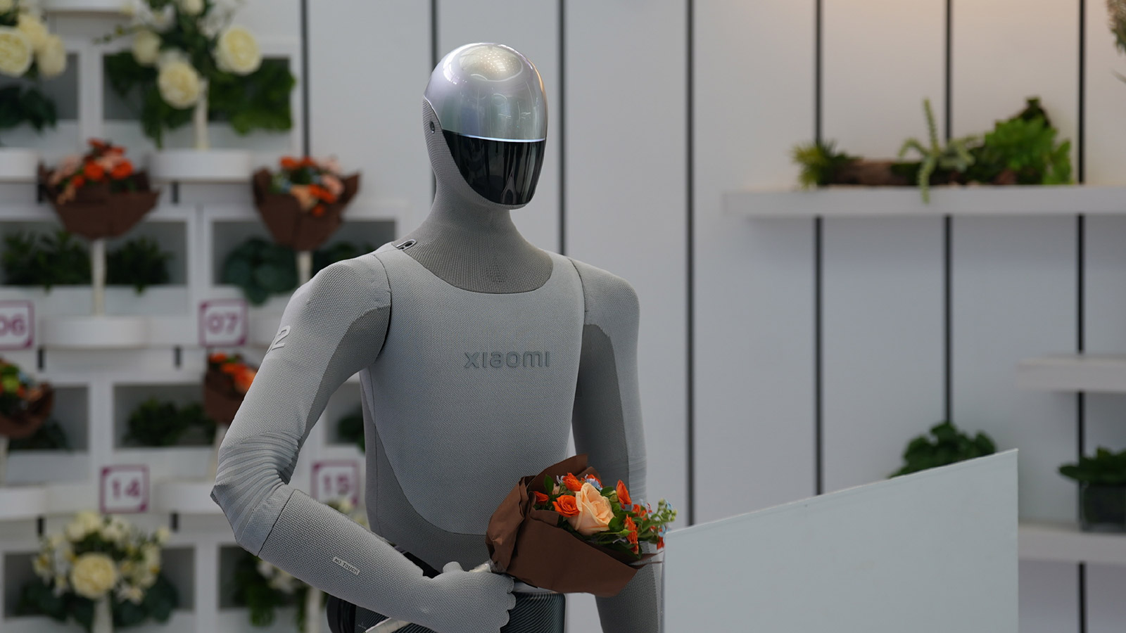 Xiaomi's next-generation humanoid robot holding a bouquet of flowers at the 2026 World Robot Conference.