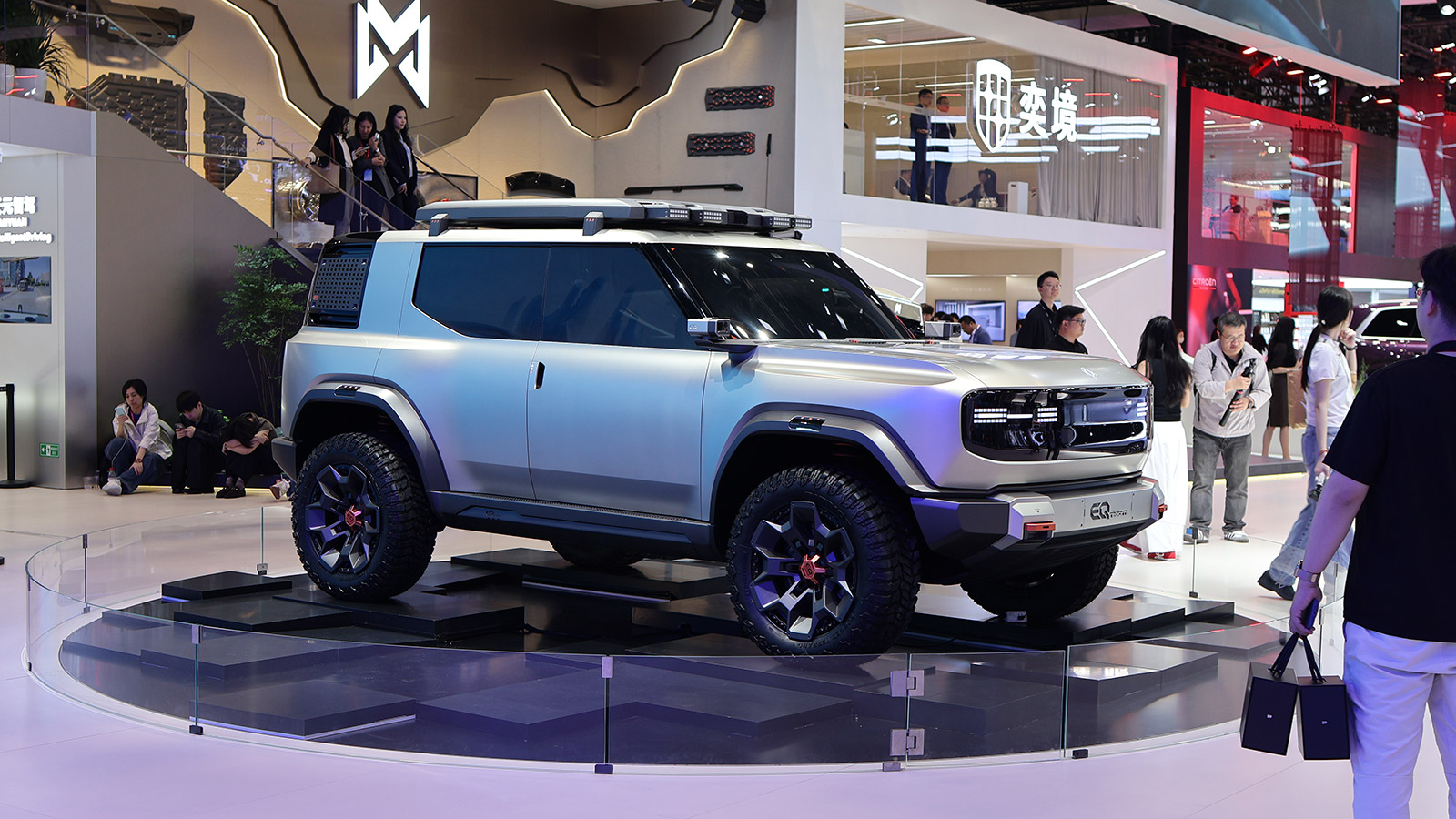 Silver Dongfeng concept SUV with chunky off-road tires and roof-mounted lights on display at the 2026 Beijing Auto Show.