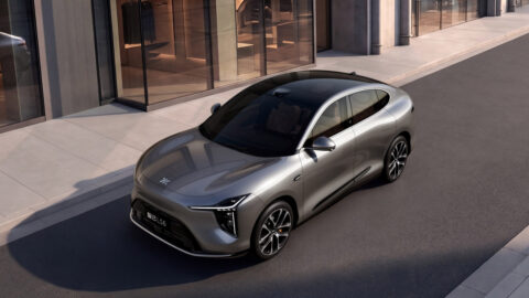 Front three-quarter view of a gray IM LS6, showing its sculpted hood, slim headlights and black panoramic roof.