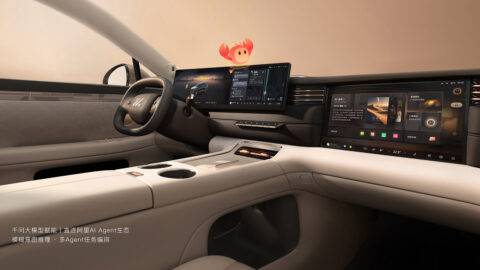 Updated IM LS6 cockpit with beige trim, a steering wheel, digital dashboard and front passenger entertainment screen.