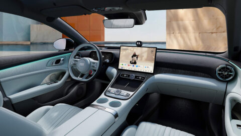 Geely Galaxy TT cockpit with light blue upholstery, a central touchscreen, a digital instrument display and turquoise ambient lighting.