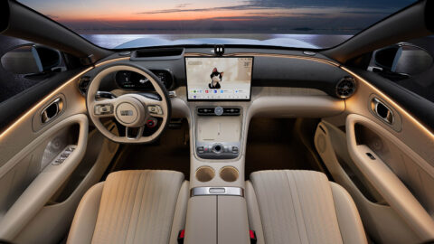 Geely Galaxy TT dashboard and center console with beige upholstery, a central touchscreen and warm ambient lighting.