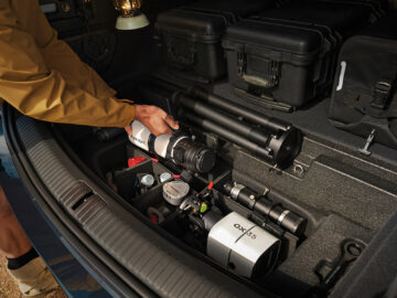 Close-up of the Onvo L80’s recessed rear storage compartment holding a telescope and accessories.
