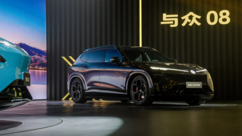 Black Volkswagen ID. UNYX 08 Lieying edition displayed on stage, showing its wheels, side profile and front fascia.
