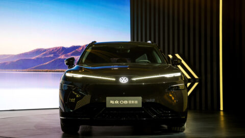 Front view of a black Volkswagen ID. UNYX 08 Lieying edition with illuminated running lights and a model-name plate.