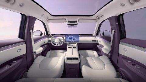 Arcfox Alpha T7 cabin with the front seats reclined, a panoramic glass roof and white-and-purple interior trim.