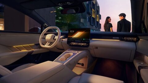 Fang Cheng Bao Formula S cabin with light-colored upholstery, a central touchscreen and ambient lighting.