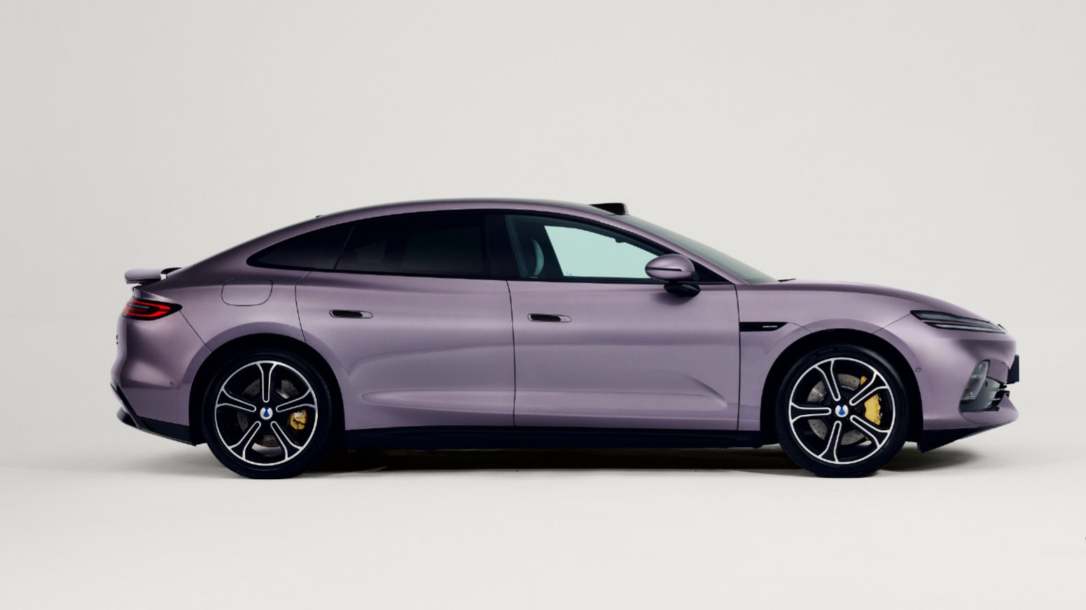 Side view of a purple Denza Z9S electric sedan with flush door handles, yellow brake calipers and a raised rear spoiler.
