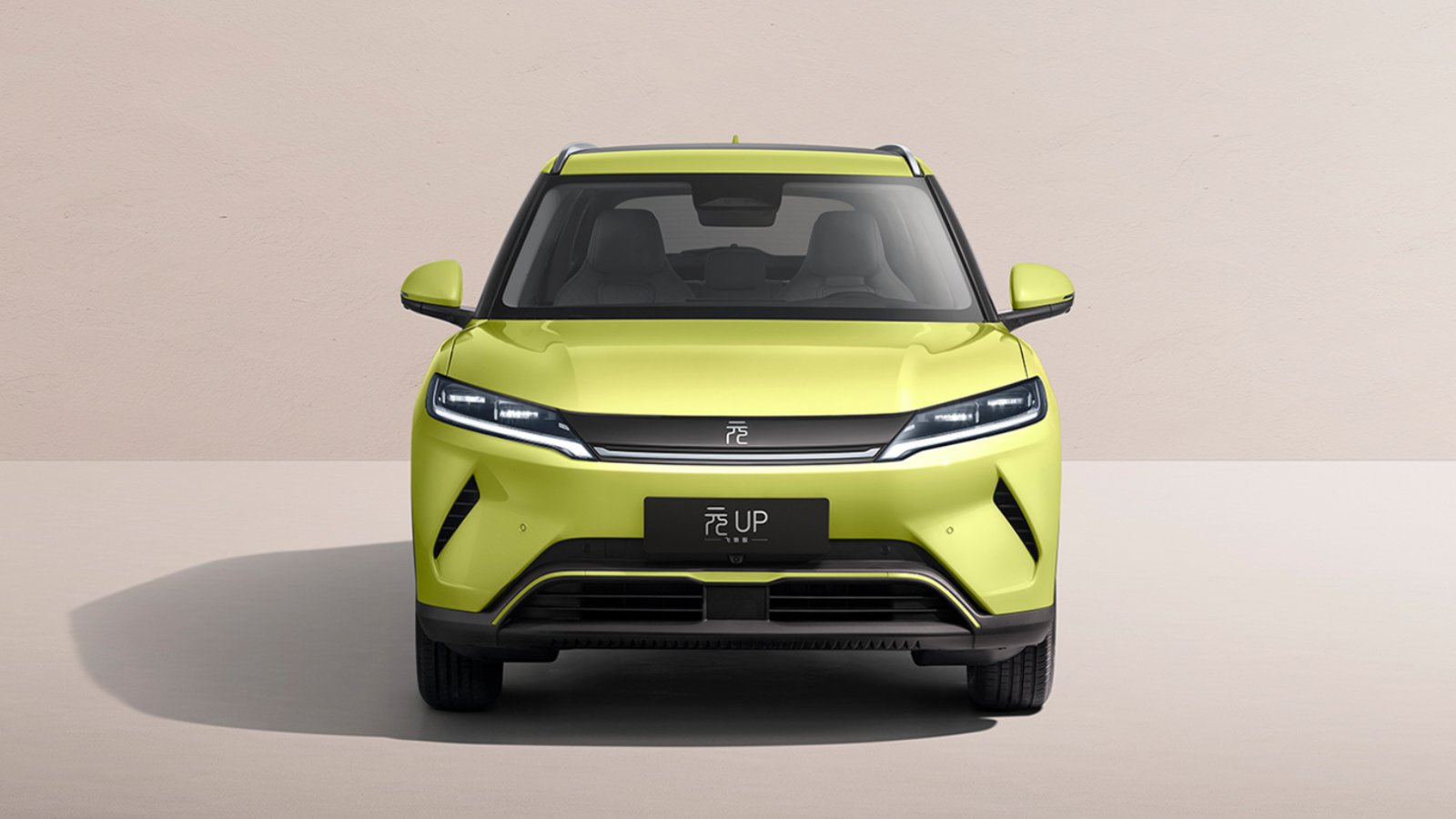 Front view of the 2027 BYD Yuan Up electric SUV in yellow, showing its headlights and black lower bumper.