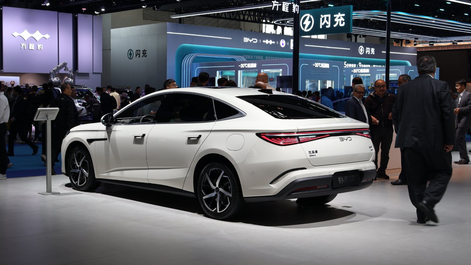Rear three-quarter view of a white BYD Seal 07 DM-i plug-in hybrid sedan at the 2026 Beijing Auto Show.