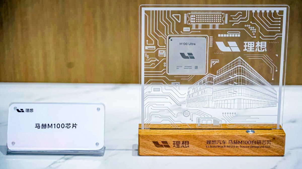 Li Auto's Mach M100 driver-assistance chip mounted in a transparent display with circuit patterns and company branding.