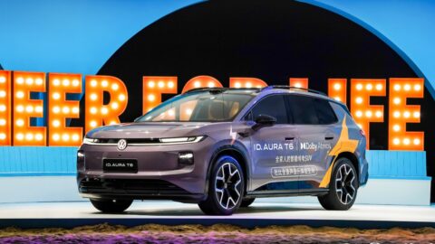 Purple FAW-Volkswagen ID. AURA T6 with Dolby Atmos branding displayed on an illuminated platform.