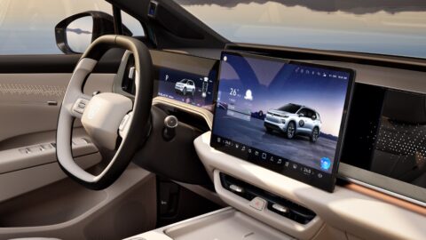 FAW-Volkswagen ID. AURA T6 cockpit with a central touchscreen, digital instrument display and beige interior trim.