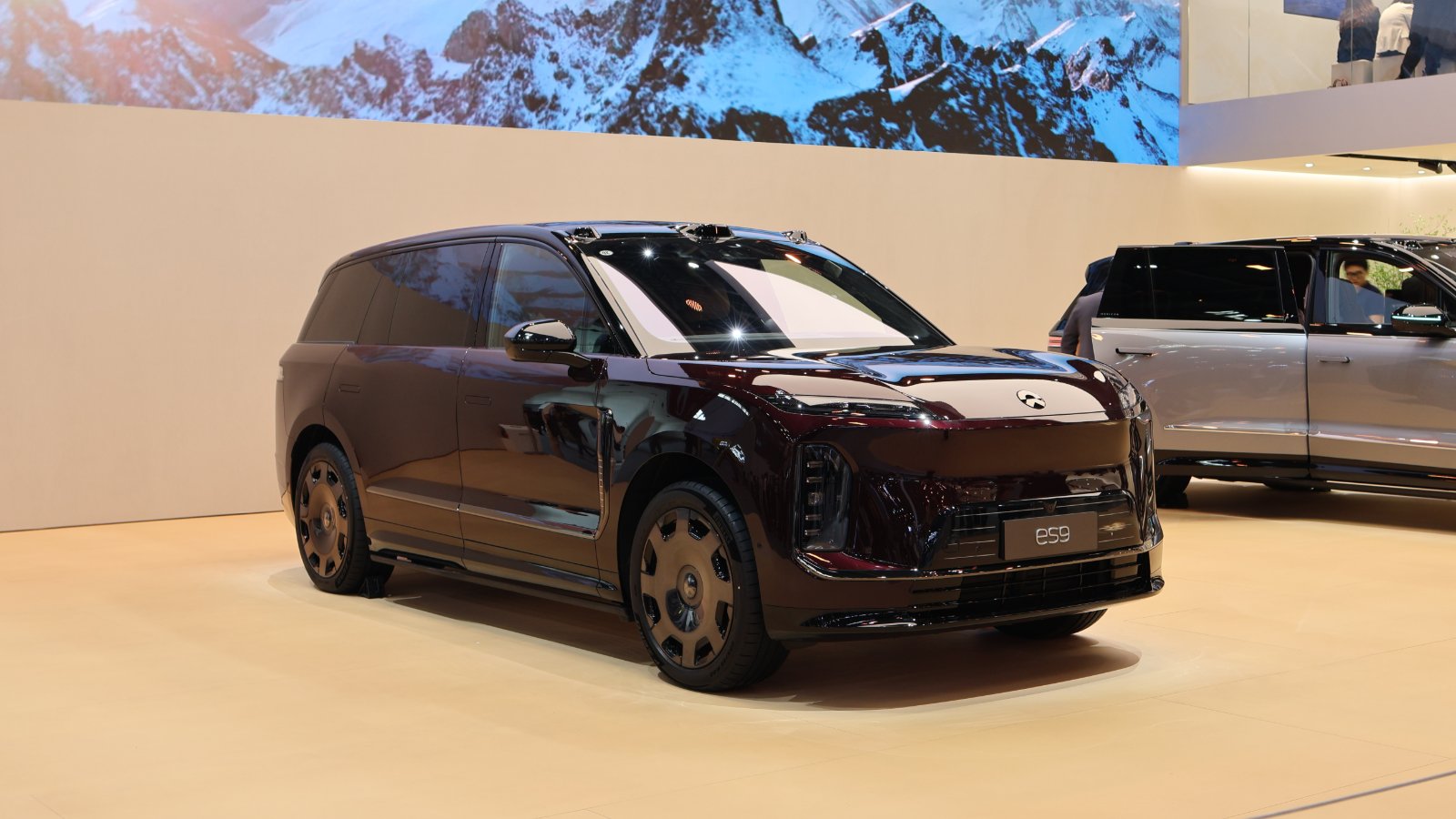 Front three-quarter view of a burgundy Nio ES9 electric SUV on display at the Beijing Auto Show in April 2026.