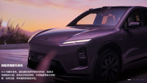 Front three-quarter close-up of the Nio EC6 Aura Edition in Aura Purple body color, parked at sunset with its headlights on and the EC6 badge visible on the front bumper.