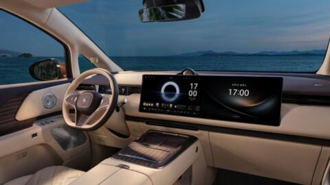 Voyah Dream 9 cockpit with cream upholstery, wood trim, a steering wheel and dual dashboard screens.