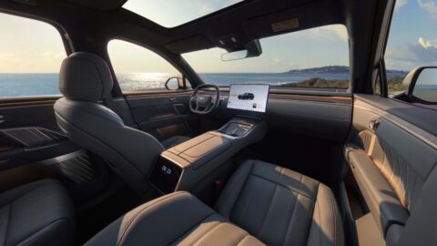 Onvo L90 Mist Gray-themed interior with gray seats, a central touchscreen and warm ambient lighting.
