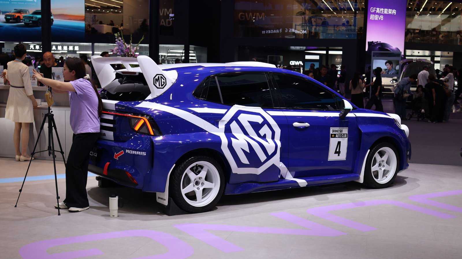 Blue MG hatchback with white racing graphics, white wheels and a large rear wing on display at the Beijing Auto Show in April 2026.