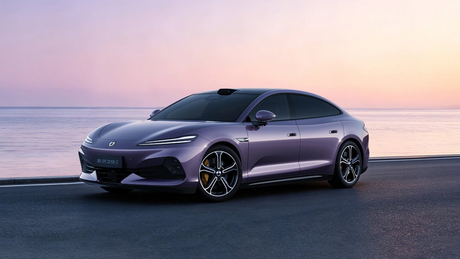 A purple Denza Z9S electric sedan parked on a coastal road at sunset, shown from the front three-quarter angle with the sea in the background.