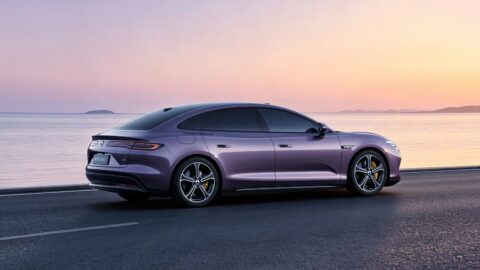 Rear three-quarter view of a purple Denza Z9S electric sedan, showing its fastback roofline and full-width taillight.