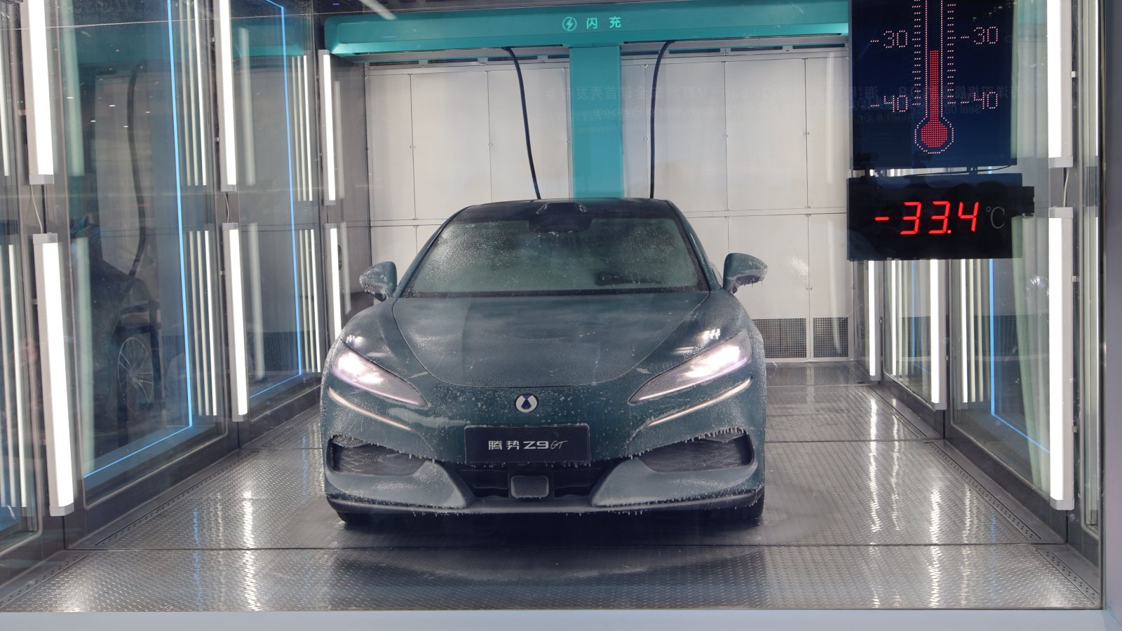 A frost-covered Denza Z9GT in a flash charging demonstration chamber, with a display showing minus 33.4 degrees Celsius.
