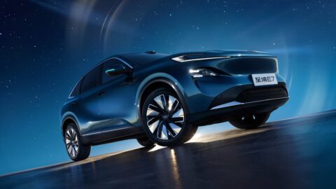 Low-angle front three-quarter view of a blue Buick Electra E7 against a starry backdrop.