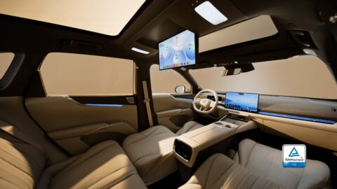 Buick Electra E7 cabin with beige reclined seats, a ceiling-mounted screen, a central touchscreen and blue ambient lighting.
