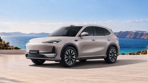 Geely Galaxy E5 electric SUV parked beside the water, shown from a front three-quarter angle.
