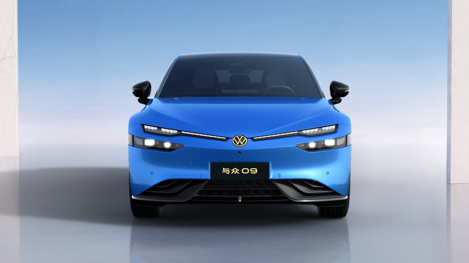Front view of a blue Volkswagen ID. UNYX 09 electric sedan with slim headlights and a gold Volkswagen badge.