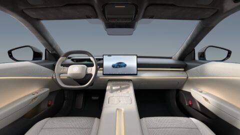 Volkswagen ID. UNYX 09 cockpit with a floating central touchscreen, a digital instrument cluster and a light-colored center console.