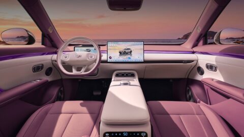 Changan Nevo Q06 cockpit with a central touchscreen, a two-spoke steering wheel and purple ambient lighting.